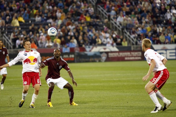 Colorado Rapids Omar Cummings (center), New York Red Bulls Seth Stammler (left), and Tim Ream (right) have their eye on the ball as the rain pounded the players during the 2010, 4th of July game at Dick's Sporting Goods Park.  The game ended in a tie 1-1.  (Photograph by Jessica Taves/coloradosoccernow.com)